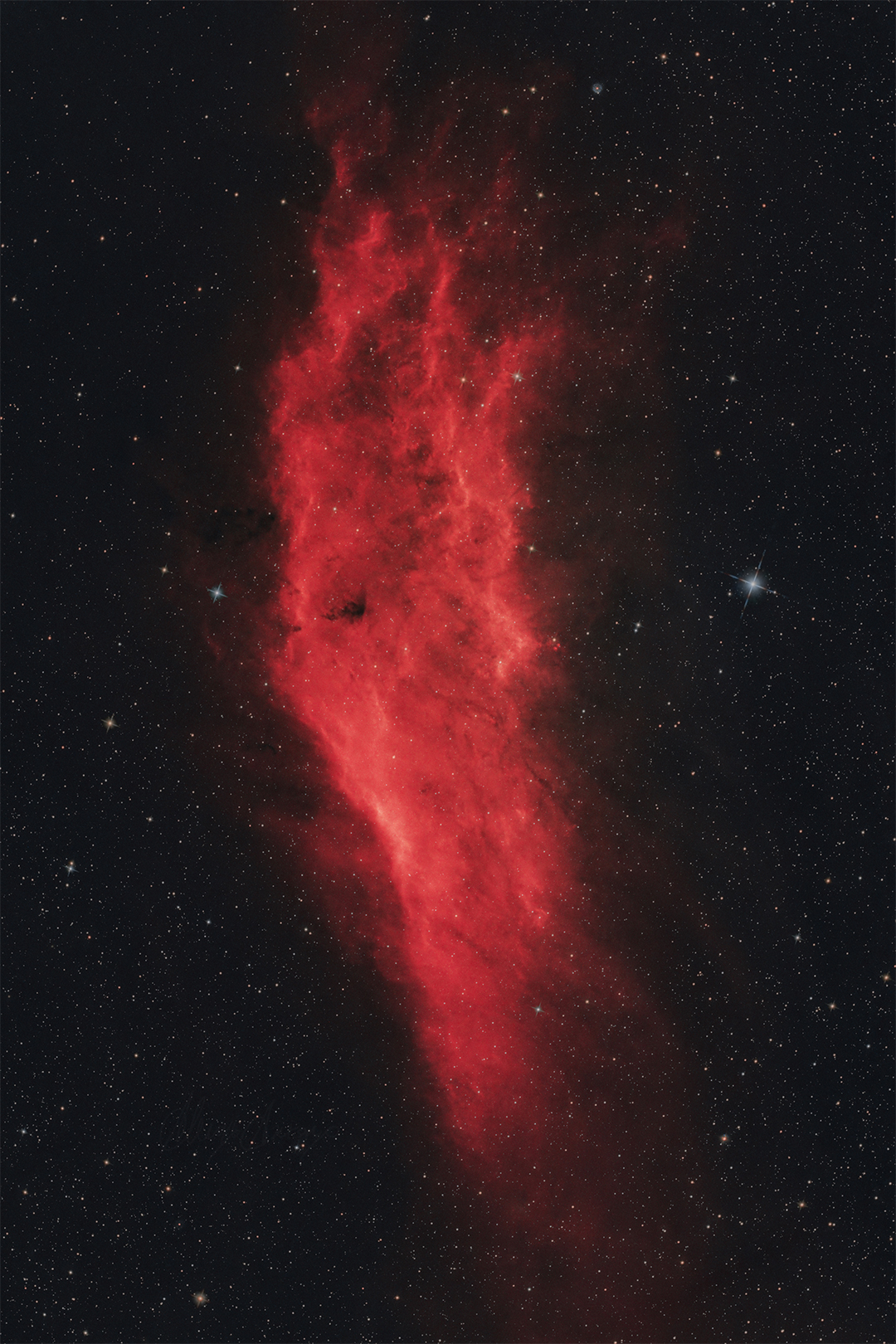 red elongated nebula with a starry background