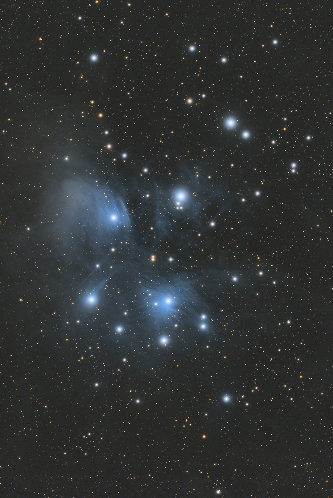 7 sisters, blue nebulosity and many bright and colorful stars. 