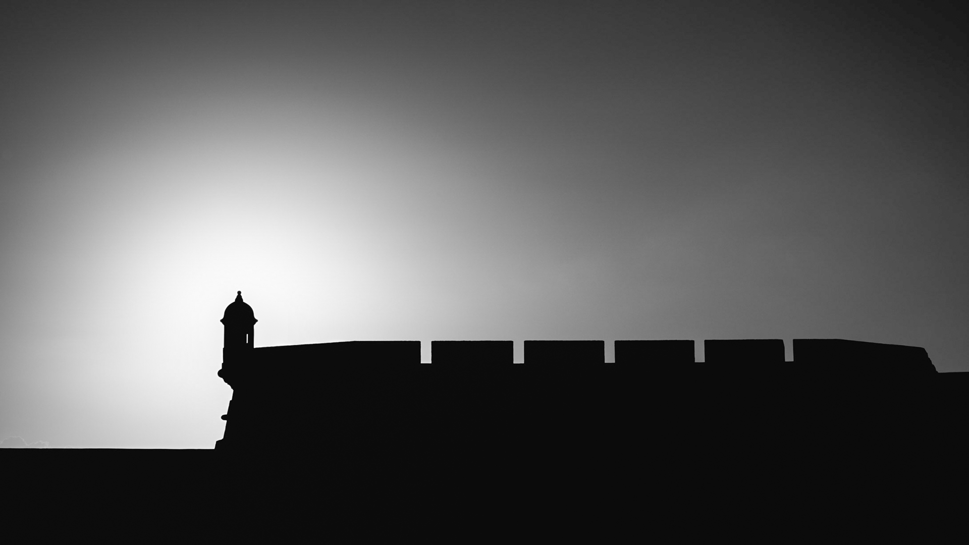 silhouette of castle with high contrast against clear skies. a backlight image. 