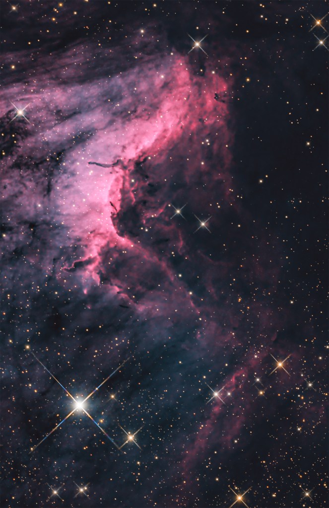 nebulosity in magenta tones stars with large spikes in deep space